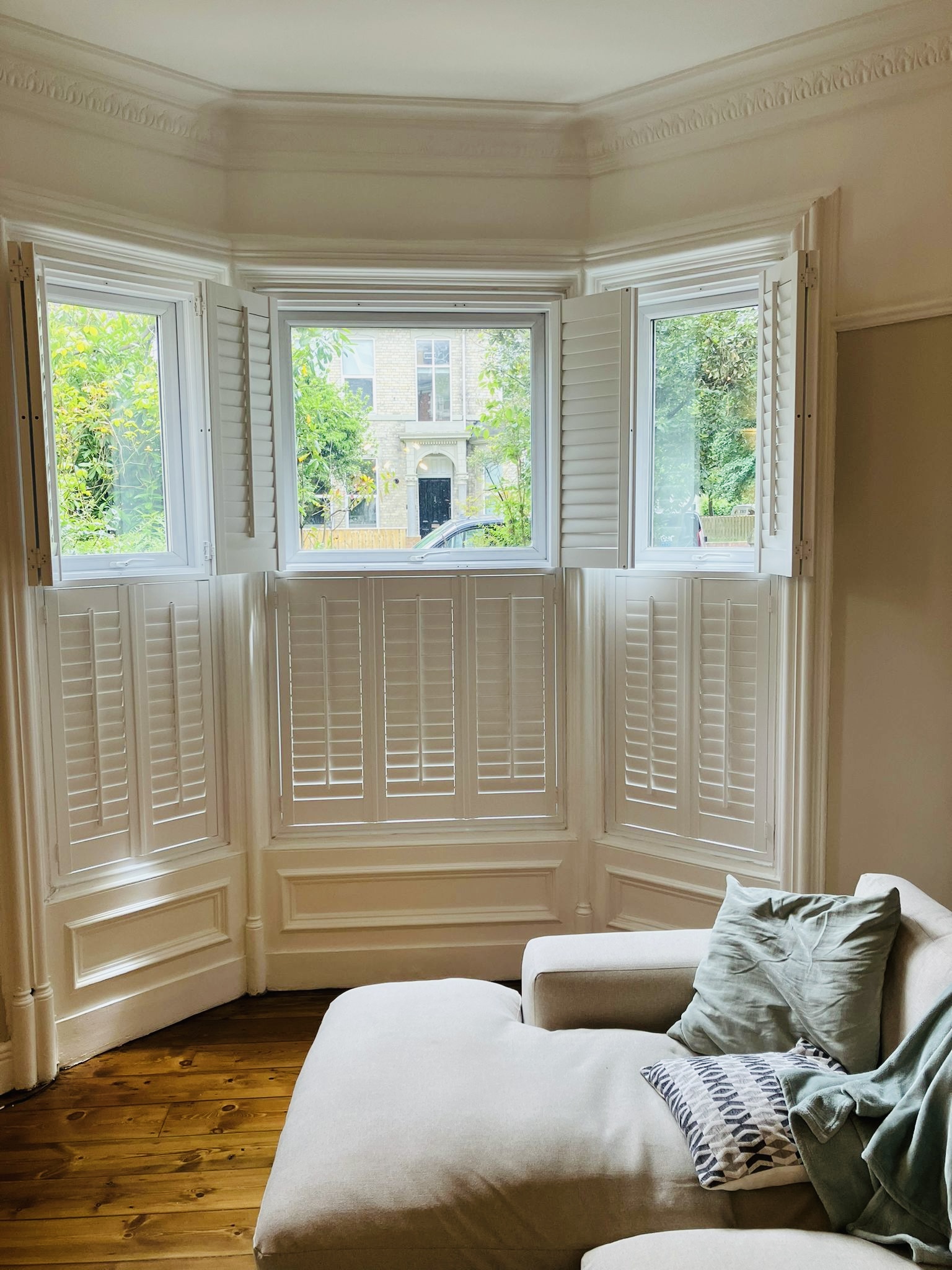Café-style plantation shutters fitted to a period bay window